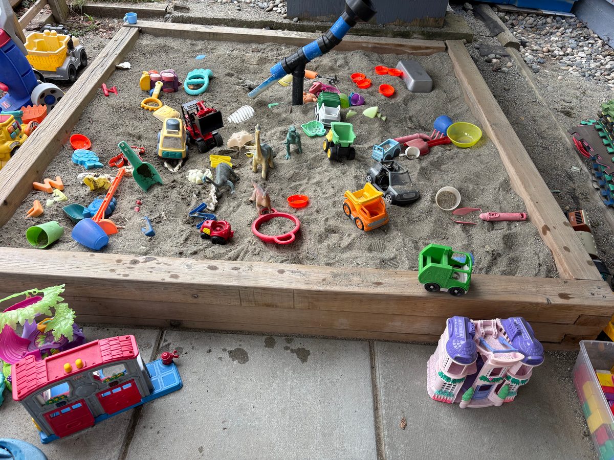 Outdoor sandbox with digging toys